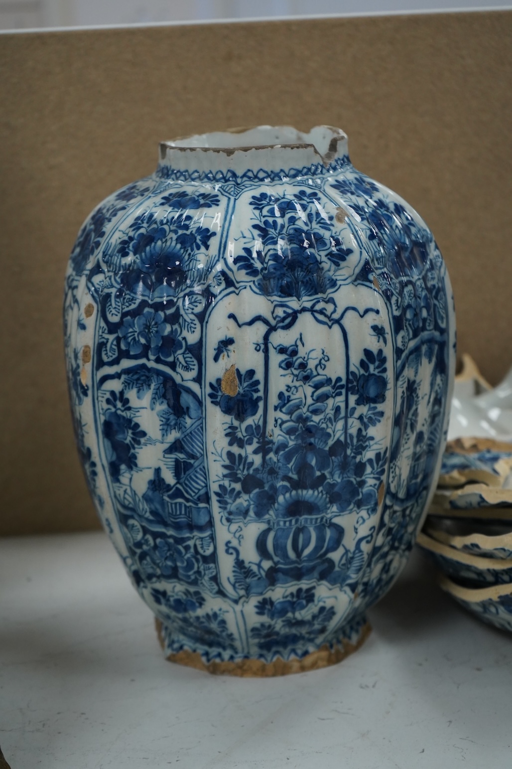 A late 17th century Delft faceted blue and white vase, by Lambartus van Eenhorn, and another broken similar, 29cm high (a.f.)